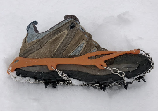 Woman's hiking shoe with attached cleat